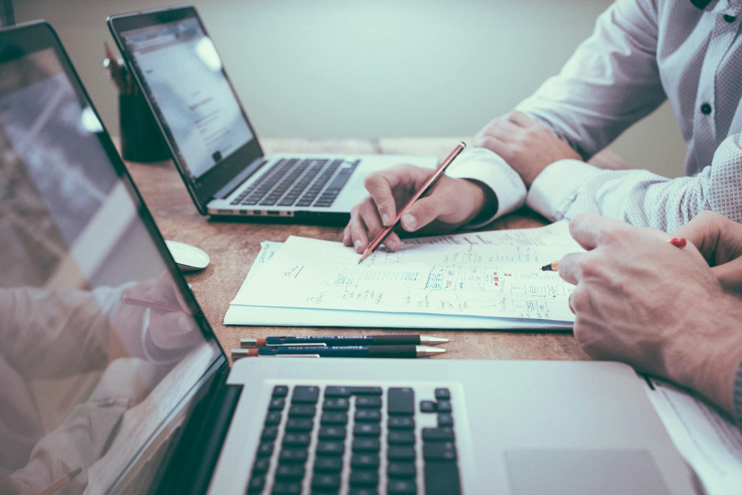Couple reviewing property documents at a kitchen table